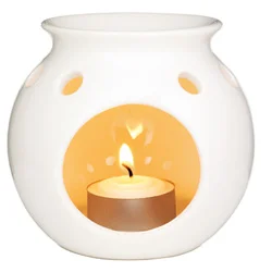 decorative oil burner with lit candle